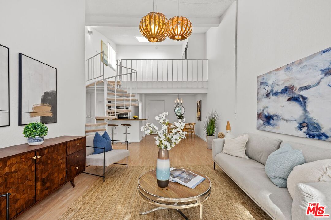 a dining room with furniture a rug and a chandelier