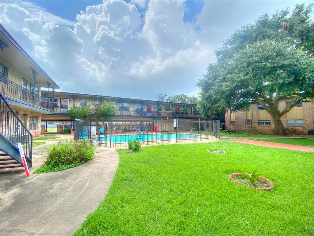 a swimming pool with outdoor seating and garden