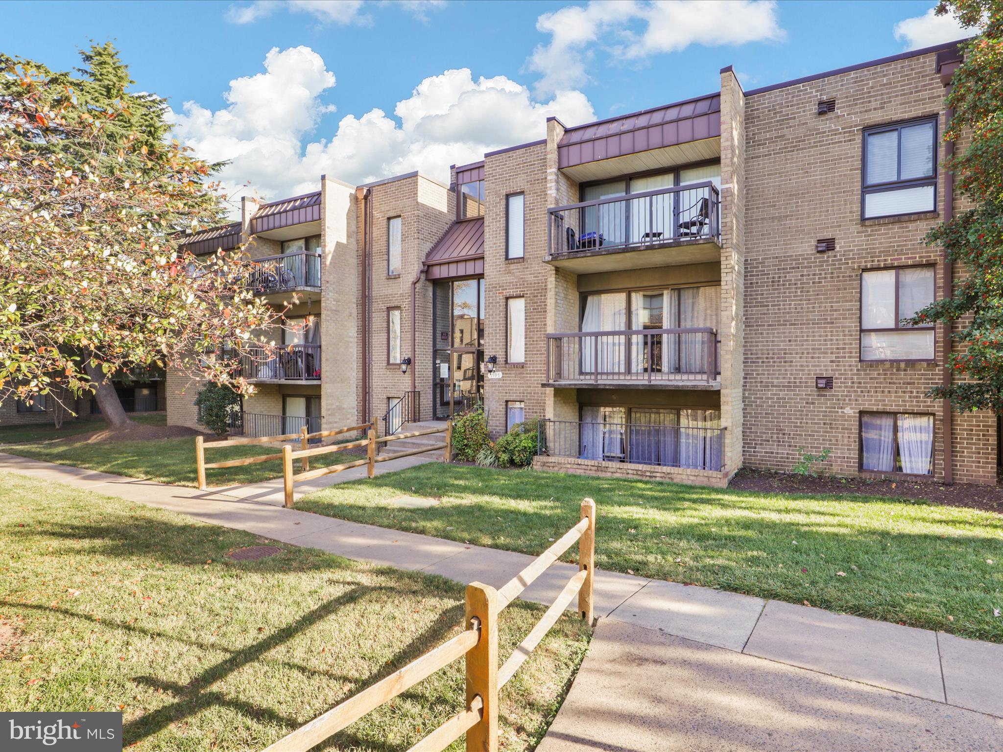 a front view of a residential apartment building with a yard