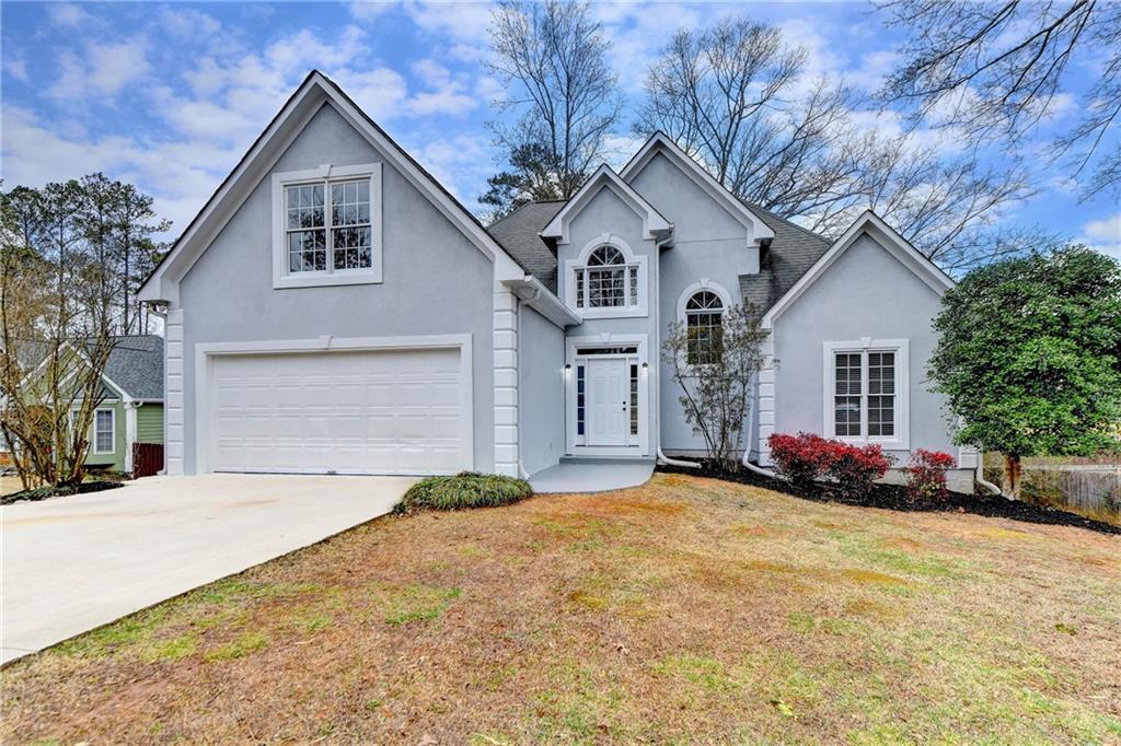 a view of a house with a yard and garage