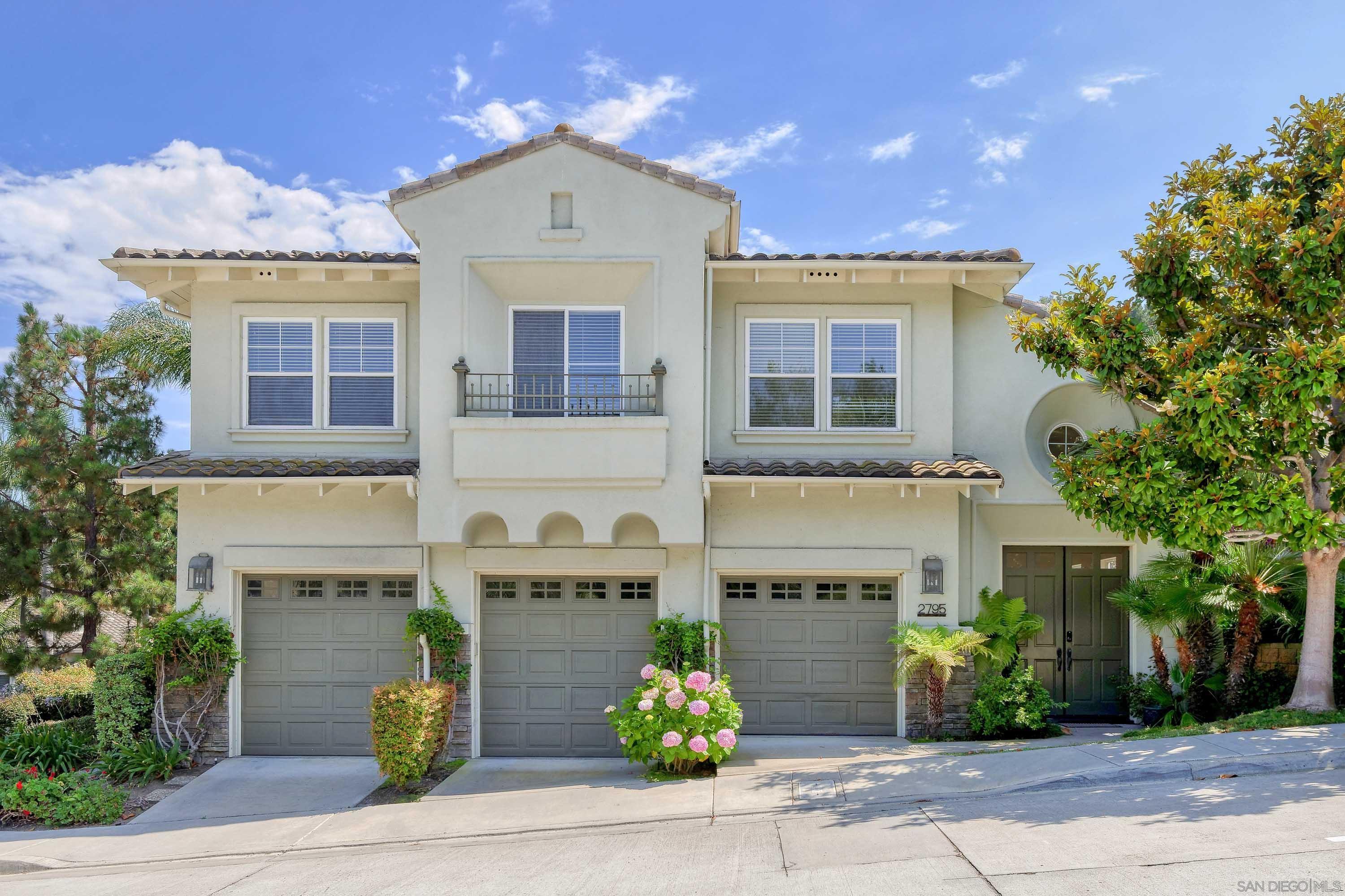 a front view of residential houses with garage