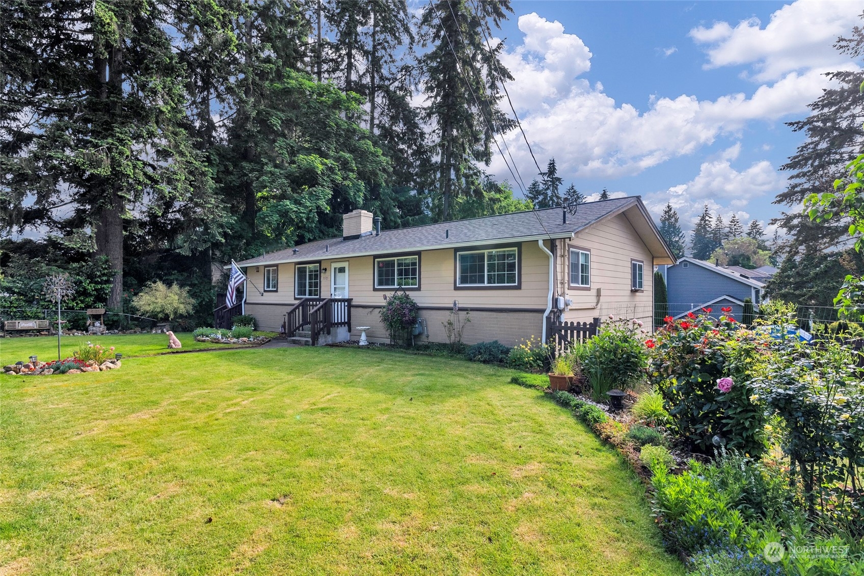 a front view of house with yard seating and green space