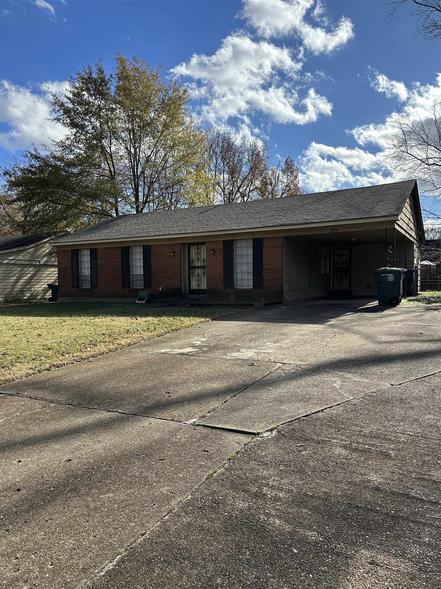 a view of house with backyard and parking space