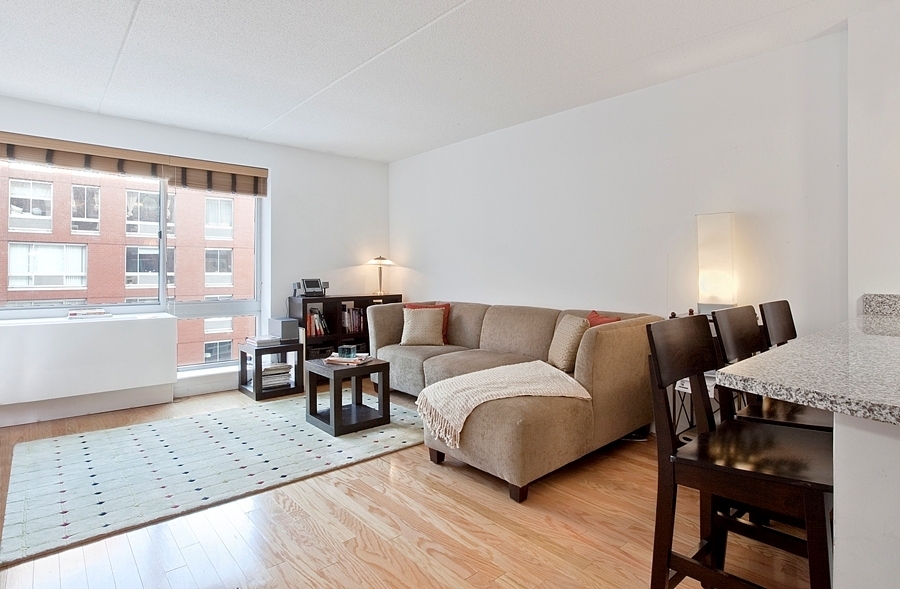 a living room with furniture a dining table and a large window