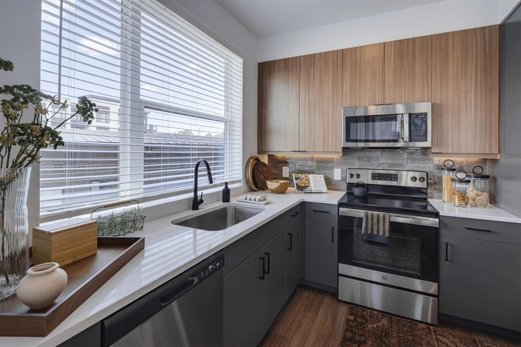 a kitchen with a sink stove and cabinets