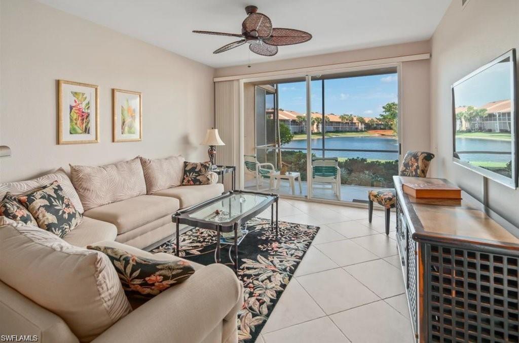 a living room with furniture and a floor to ceiling window