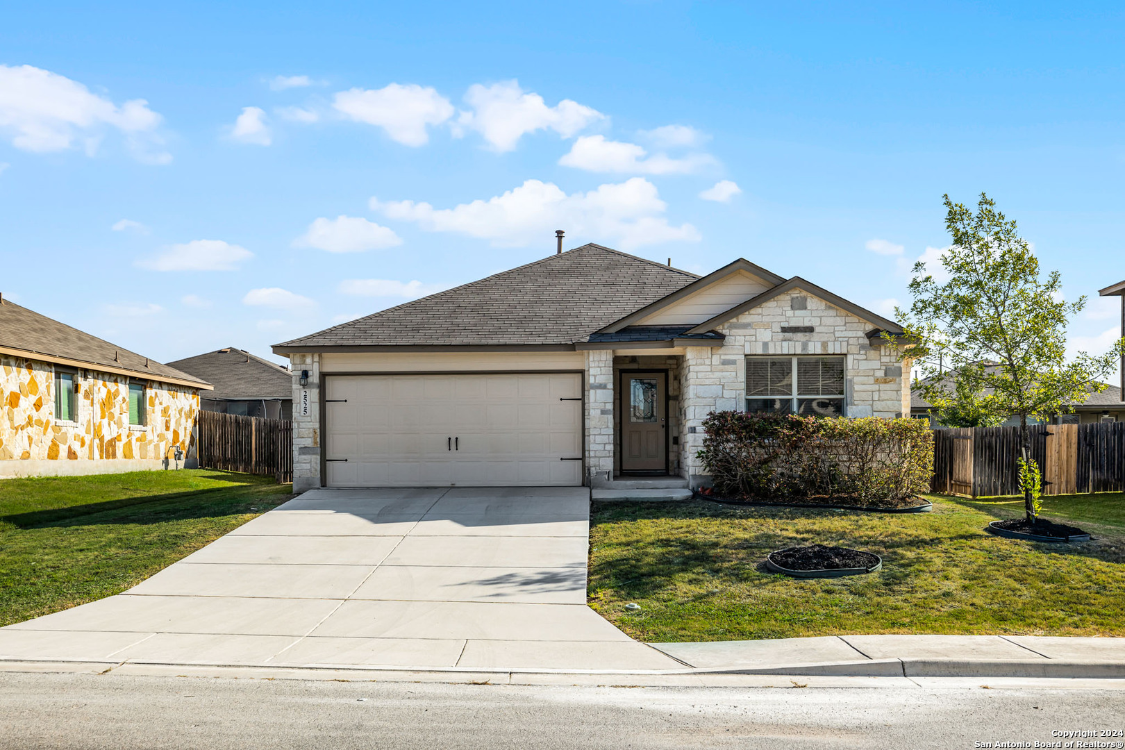 a front view of a house with a yard