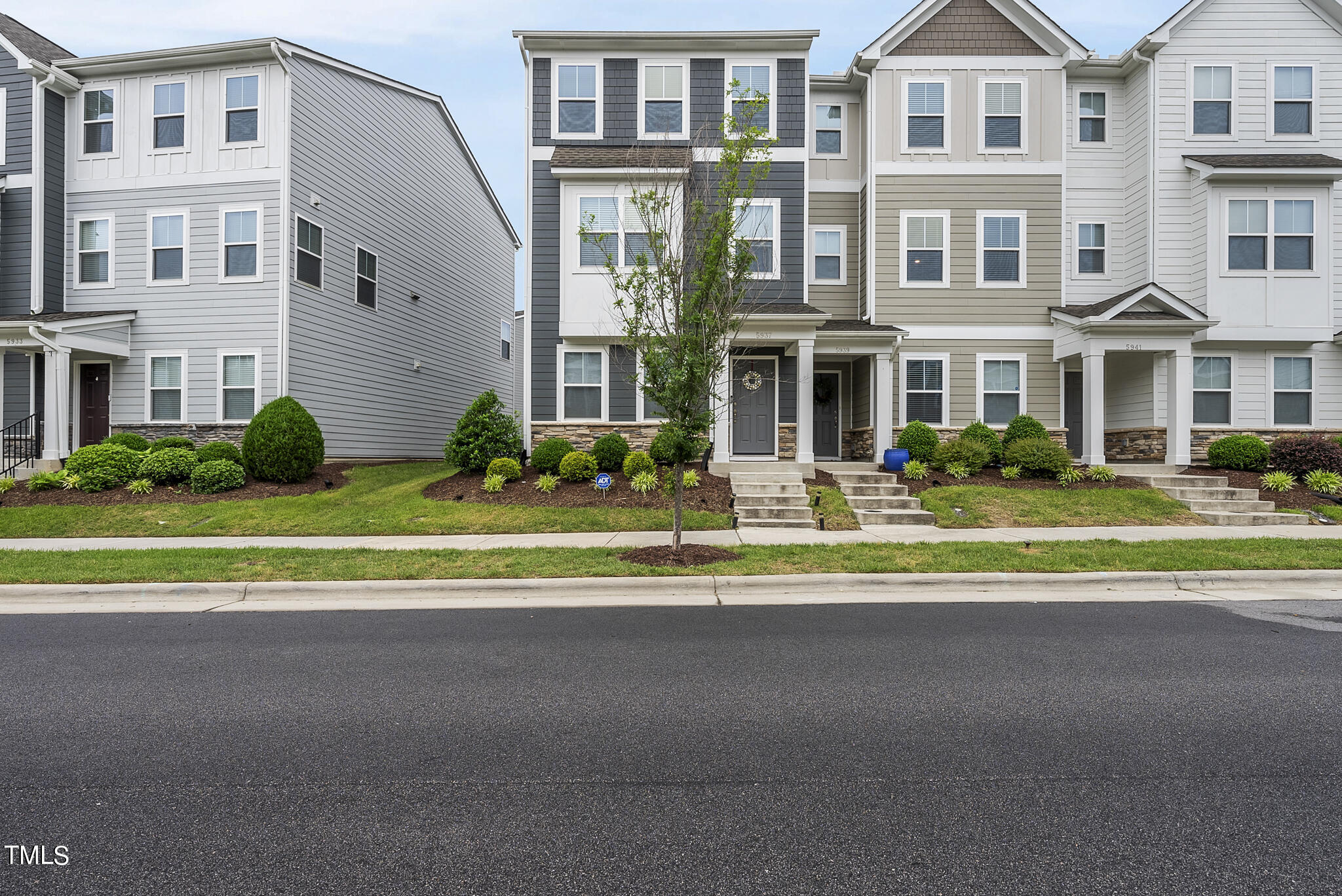 a front view of building with small yard