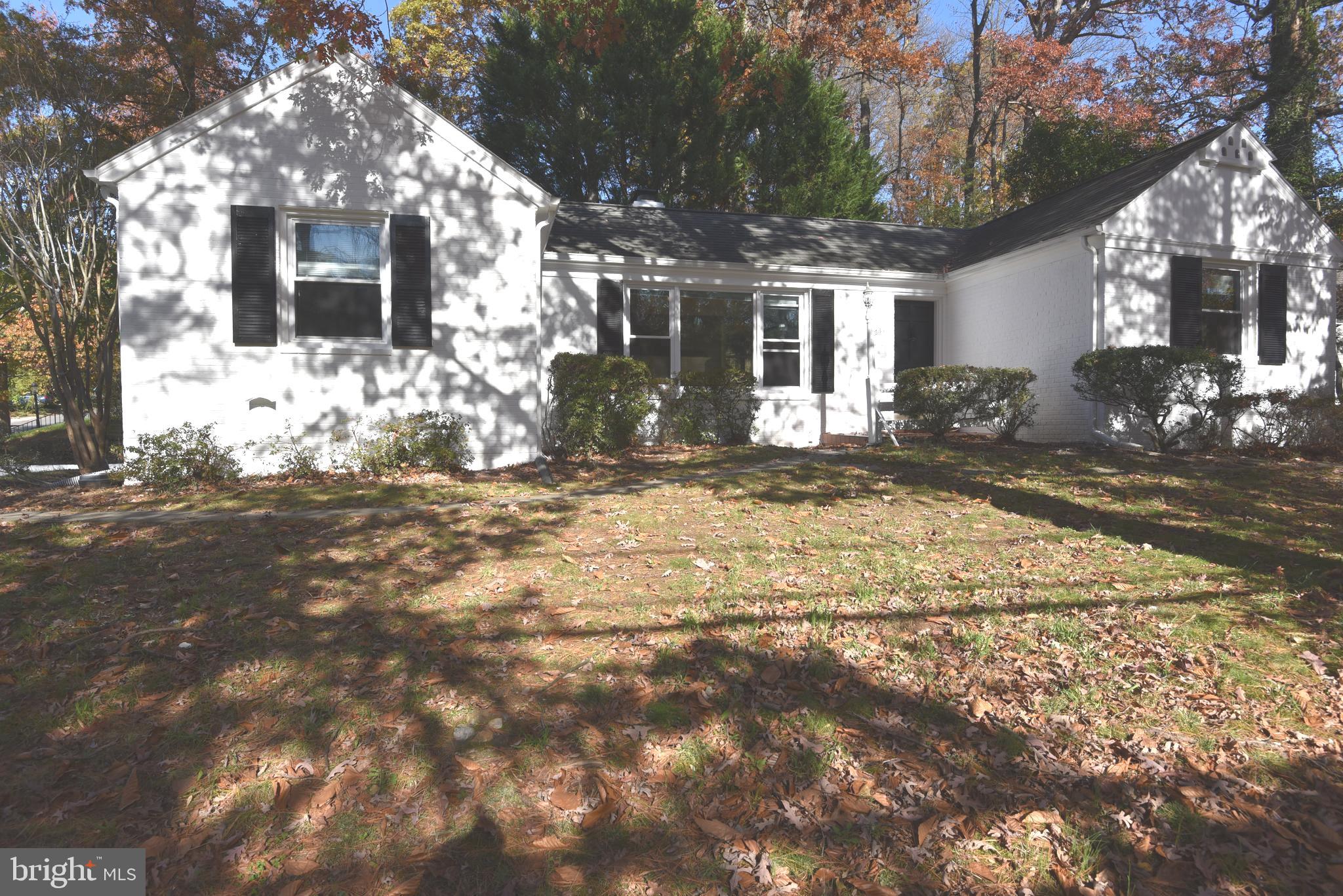 a view of a house with a yard covered in snow