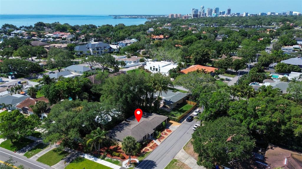 an aerial view of residential houses with outdoor space and street view