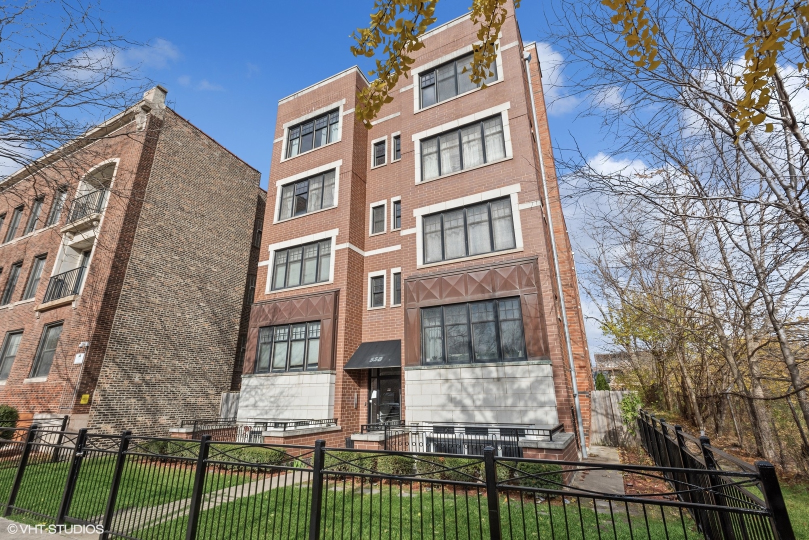 a view of a brick building next to a yard