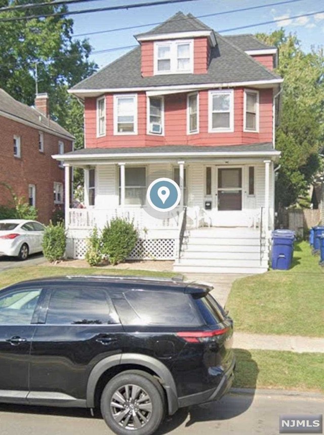 a front view of a house with parking space