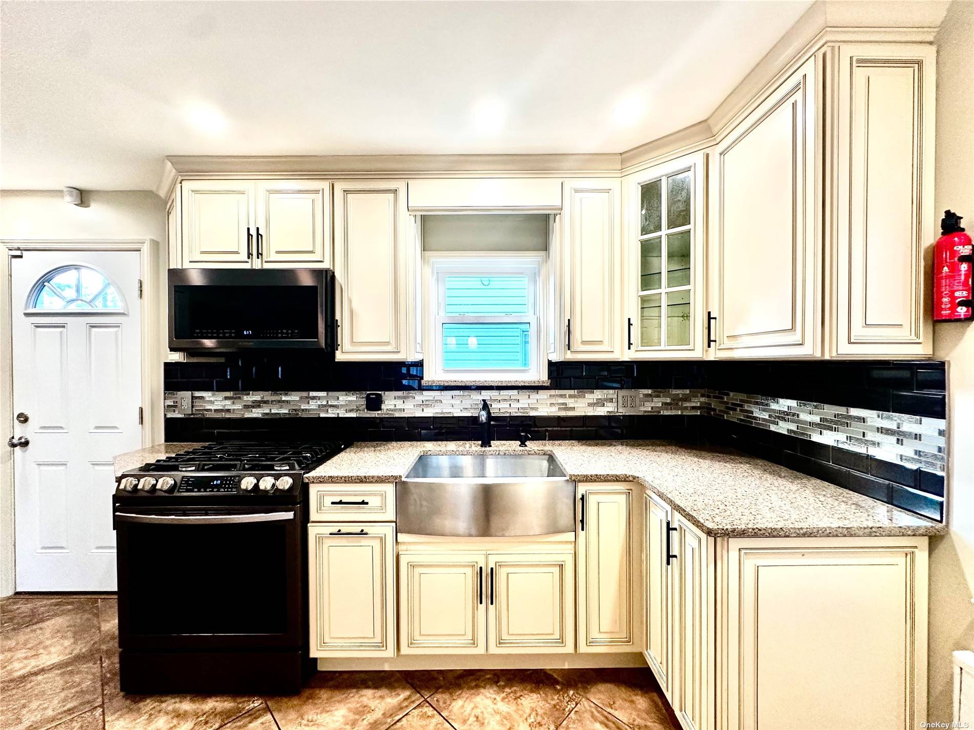 a kitchen with a sink a stove and cabinets