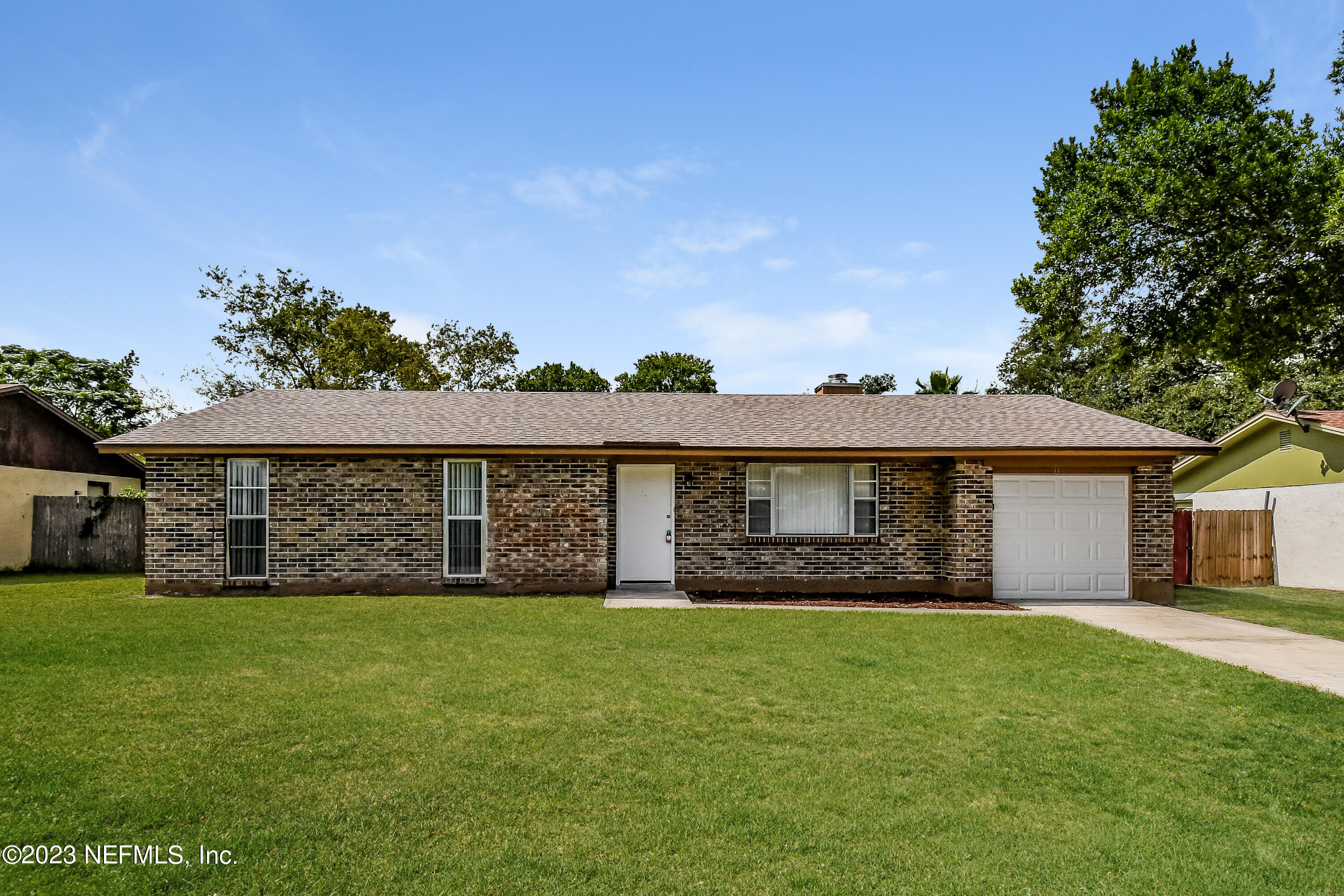 a front view of house with yard and green space