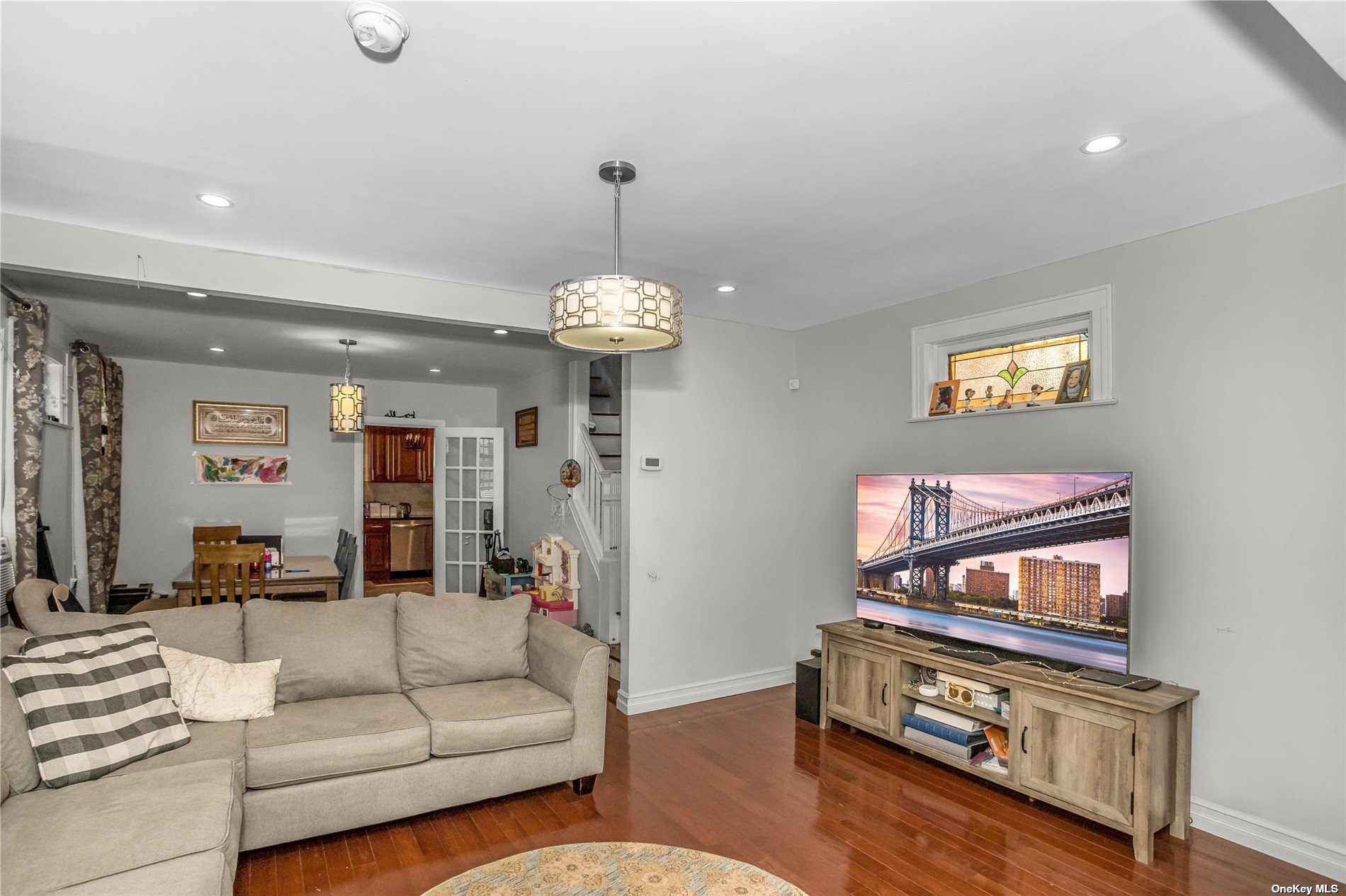 a living room with furniture a dining table and a chandelier