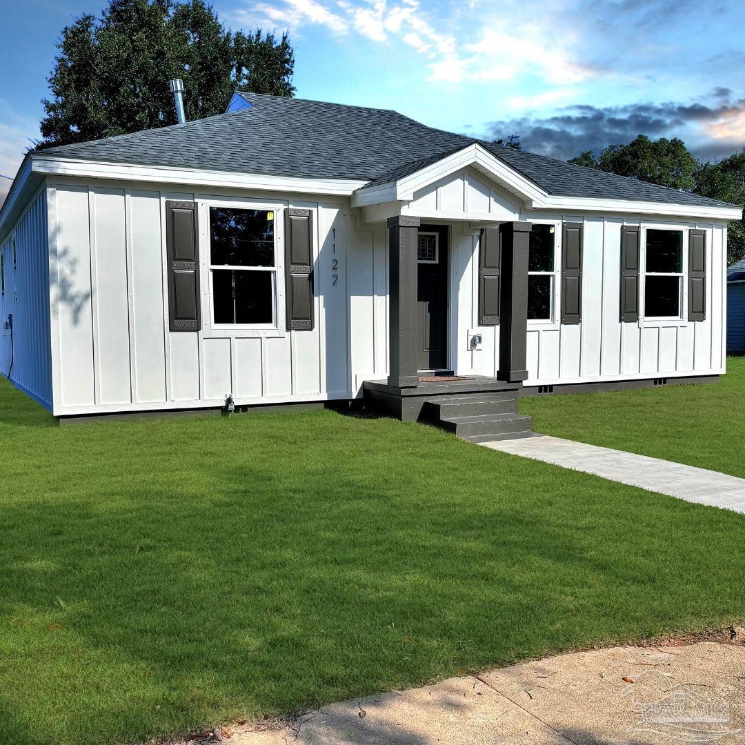 a front view of a house with a garden