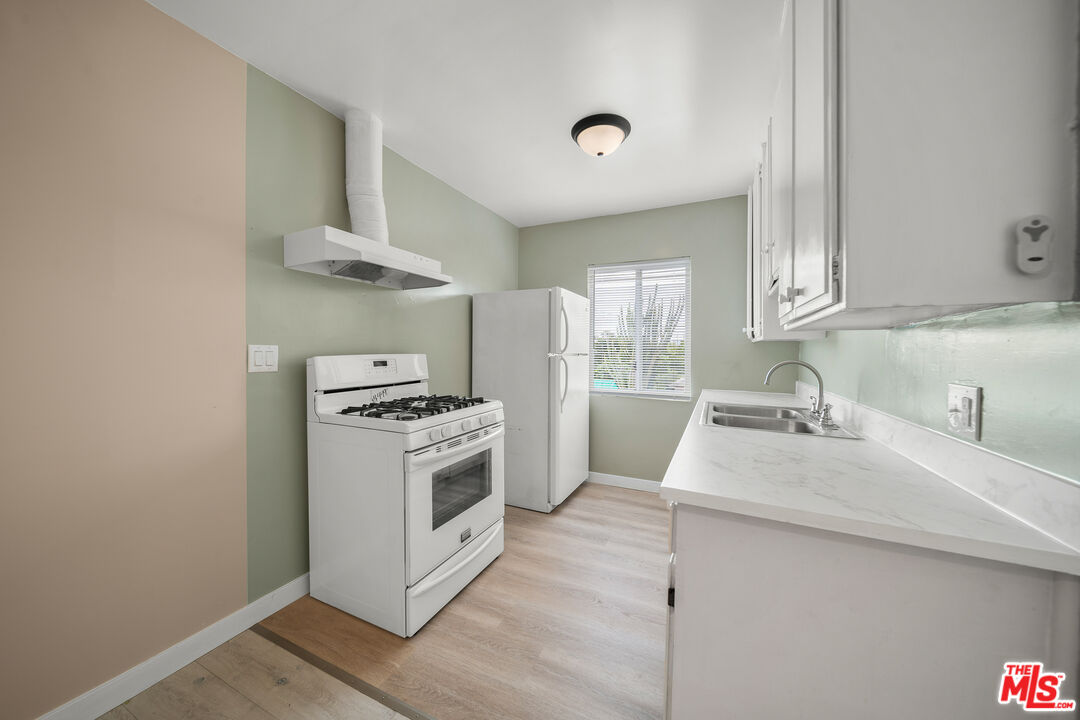 a kitchen with a stove and a sink