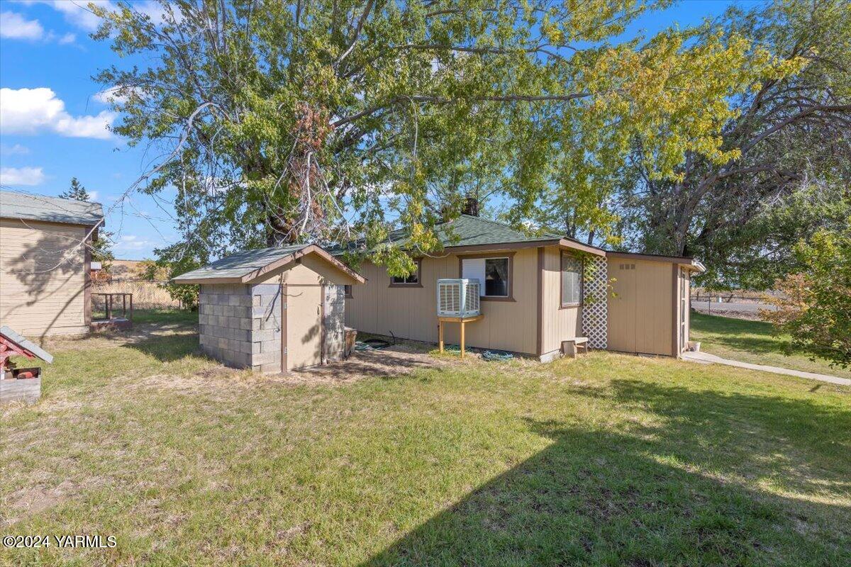 a house that has a tree in front of it