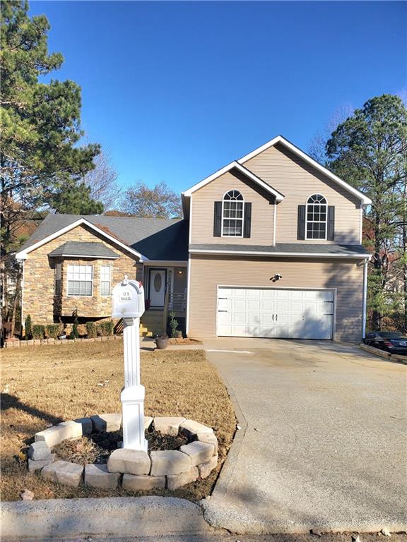 a front view of a house with a yard