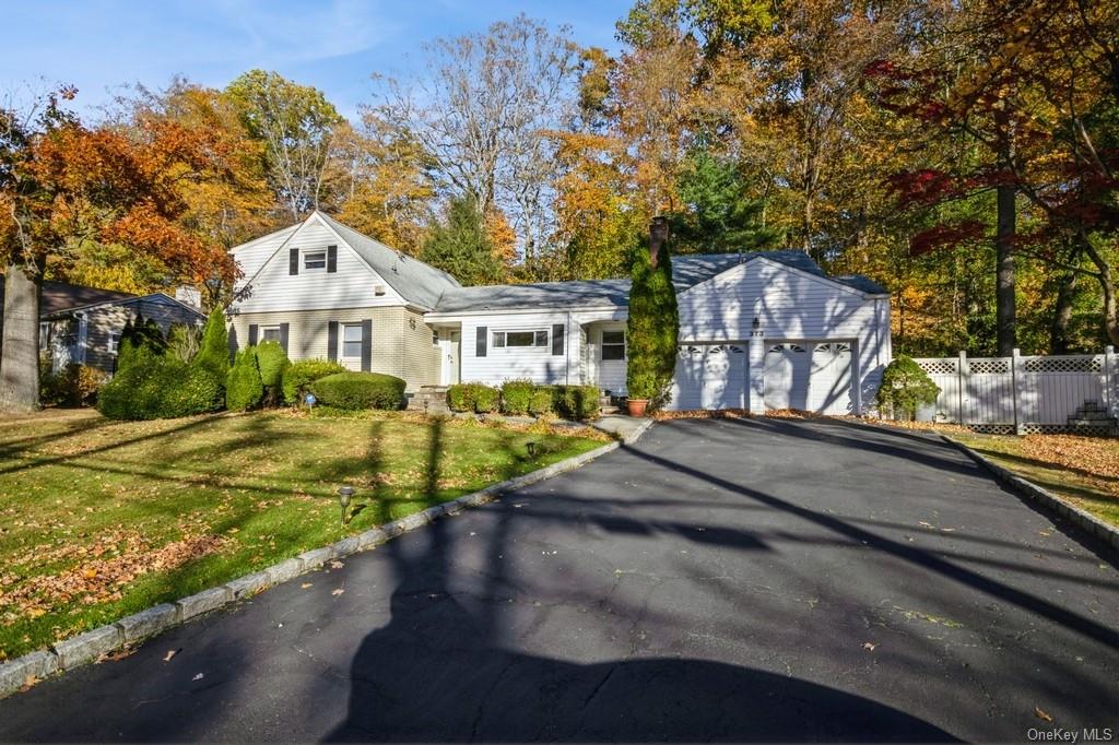 View of front of house featuring a front yard and a garage