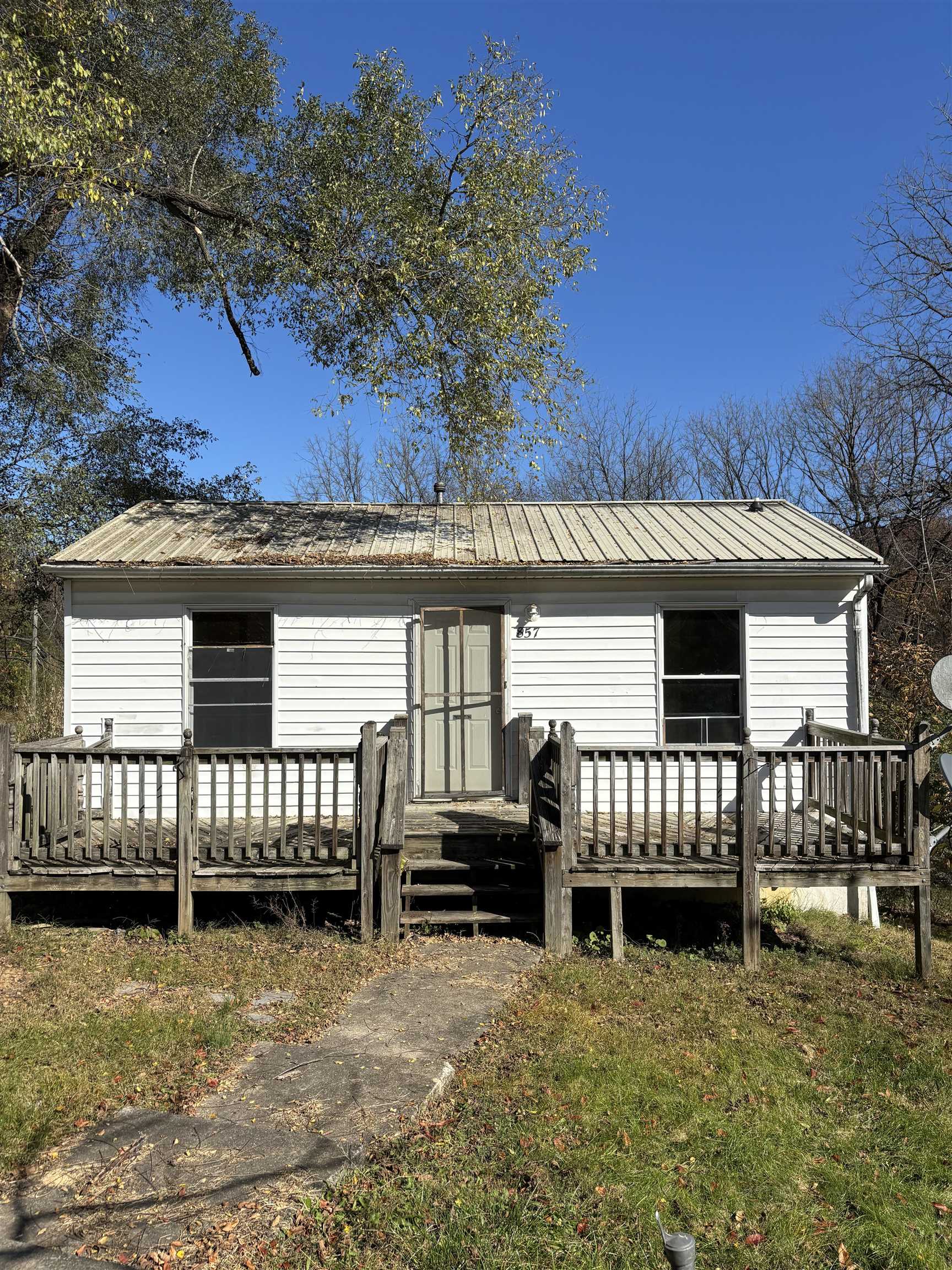 a view of a house with a wooden deck