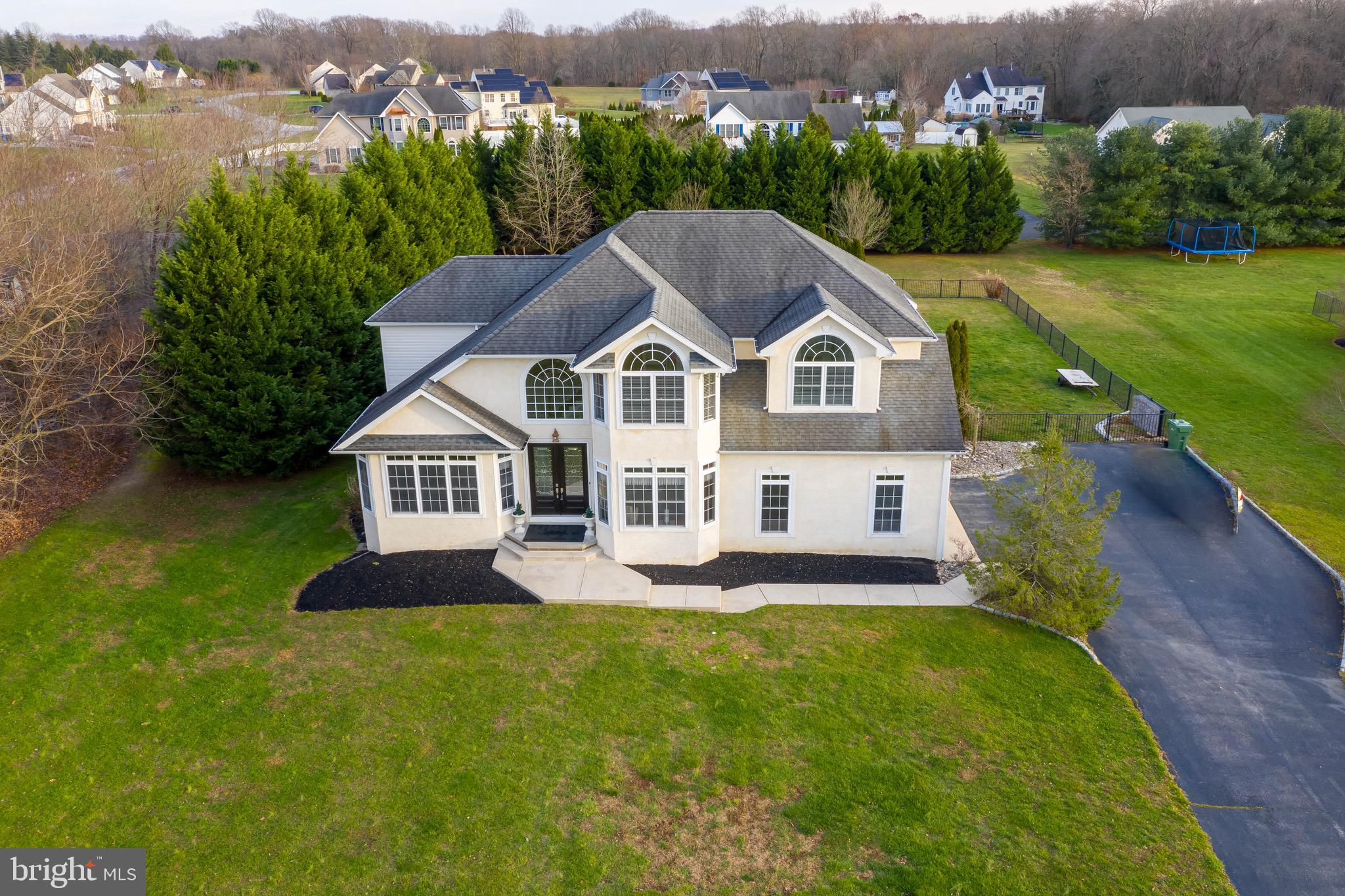 an aerial view of a house with swimming pool and mountains