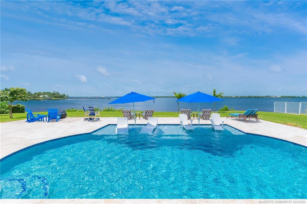 a view of a swimming pool with an outdoor space and seating area