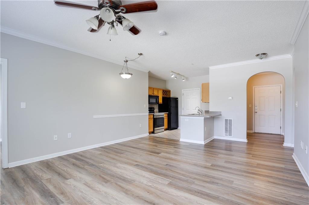 a view of a kitchen with furniture and wooden floor