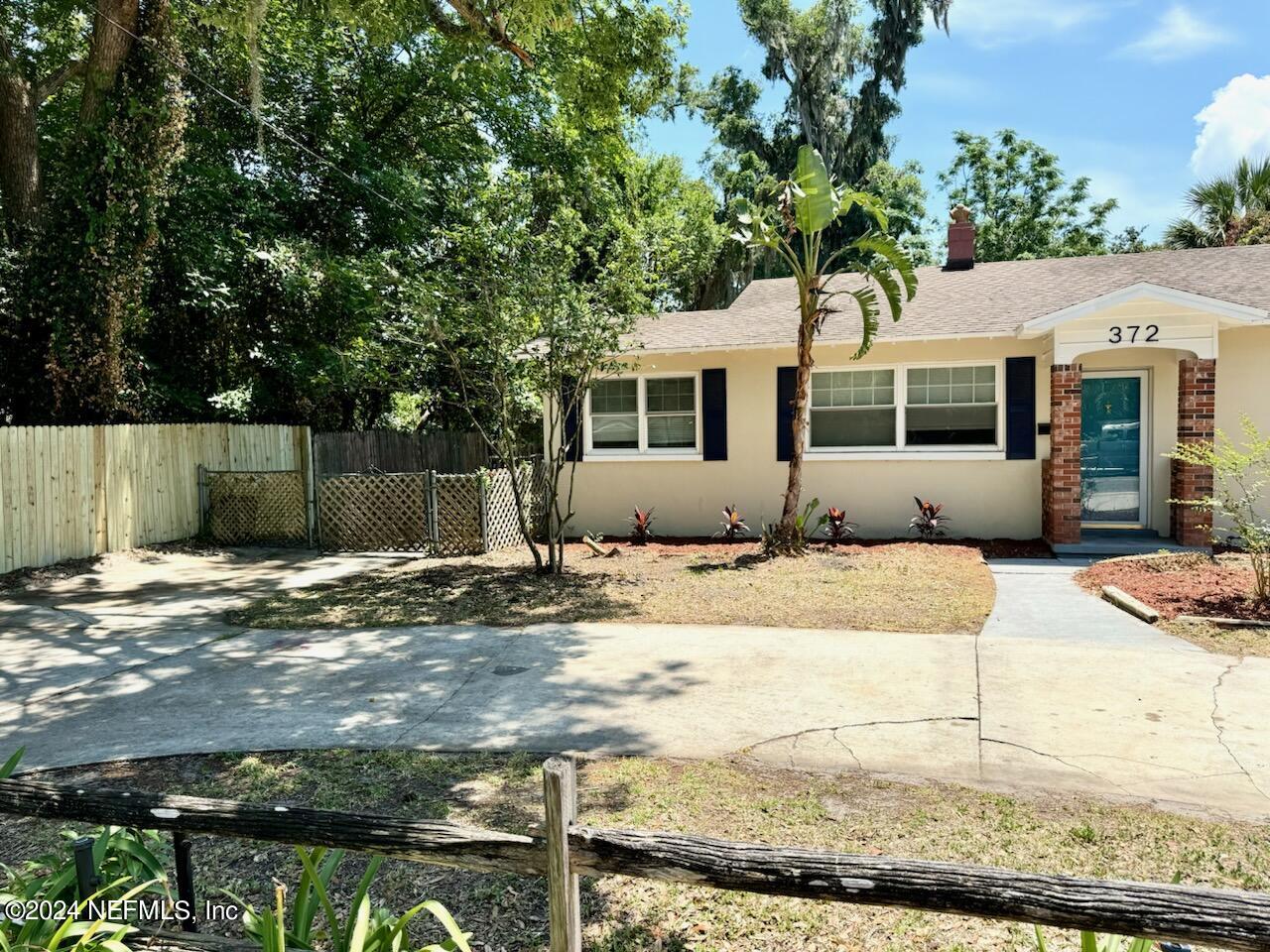 a front view of a house with trees