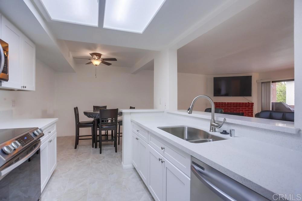 a kitchen with a sink cabinets and appliances