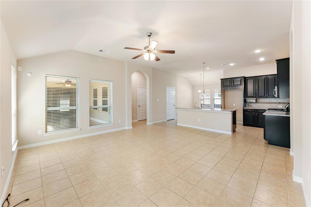 a view of an empty room with a kitchen