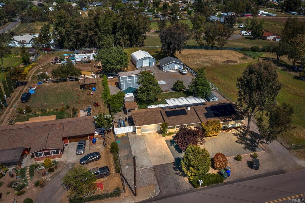 an aerial view of a house with a yard basket ball court and outdoor seating