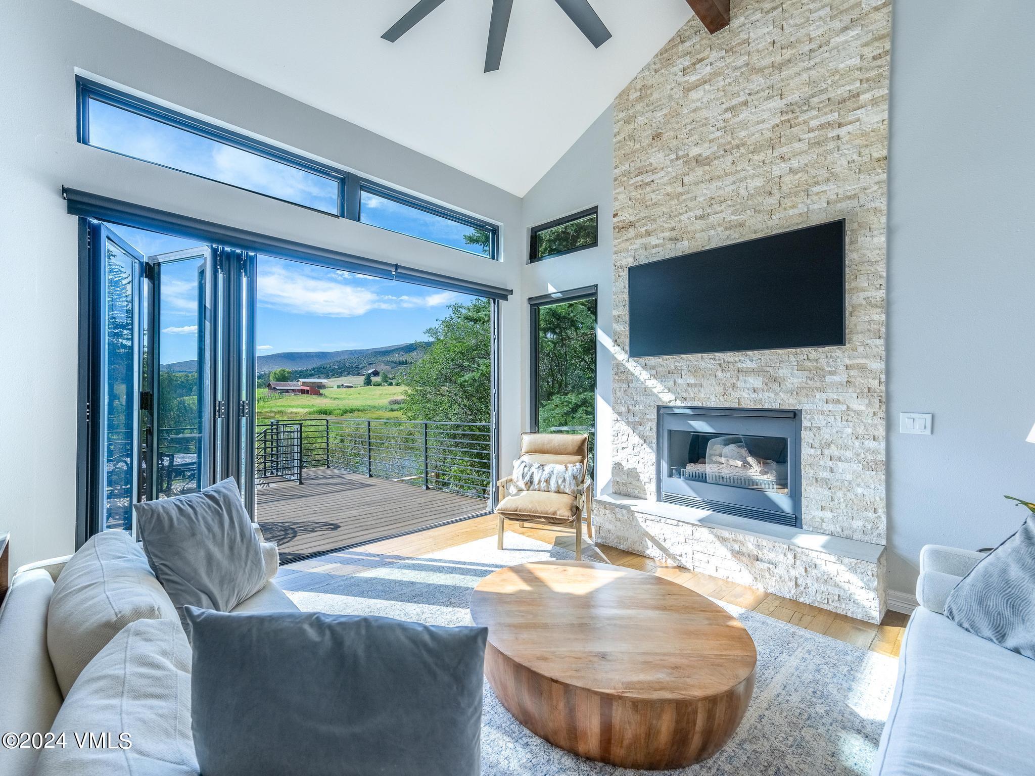 a living room with furniture a fireplace and a flat screen tv