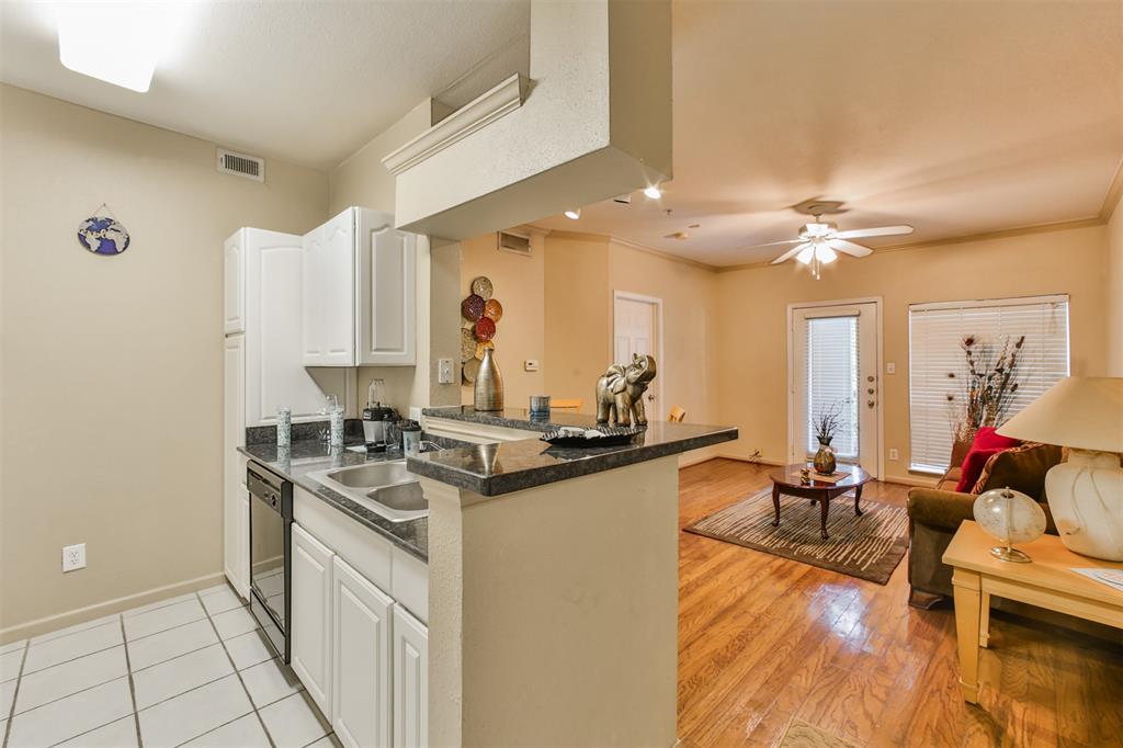 a kitchen with stainless steel appliances granite countertop a sink stove and wooden cabinets