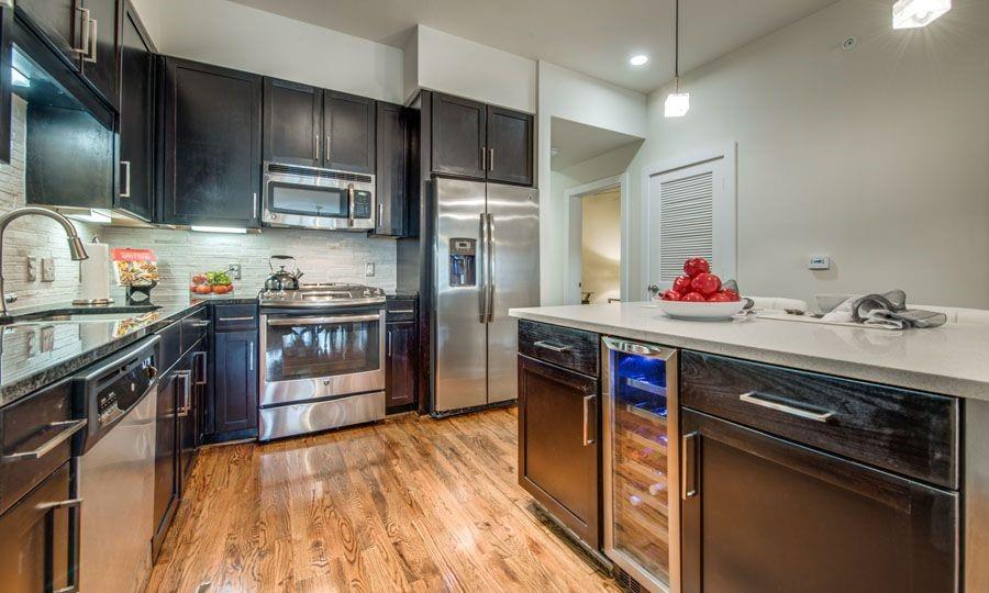 a kitchen with stainless steel appliances a sink stove and refrigerator