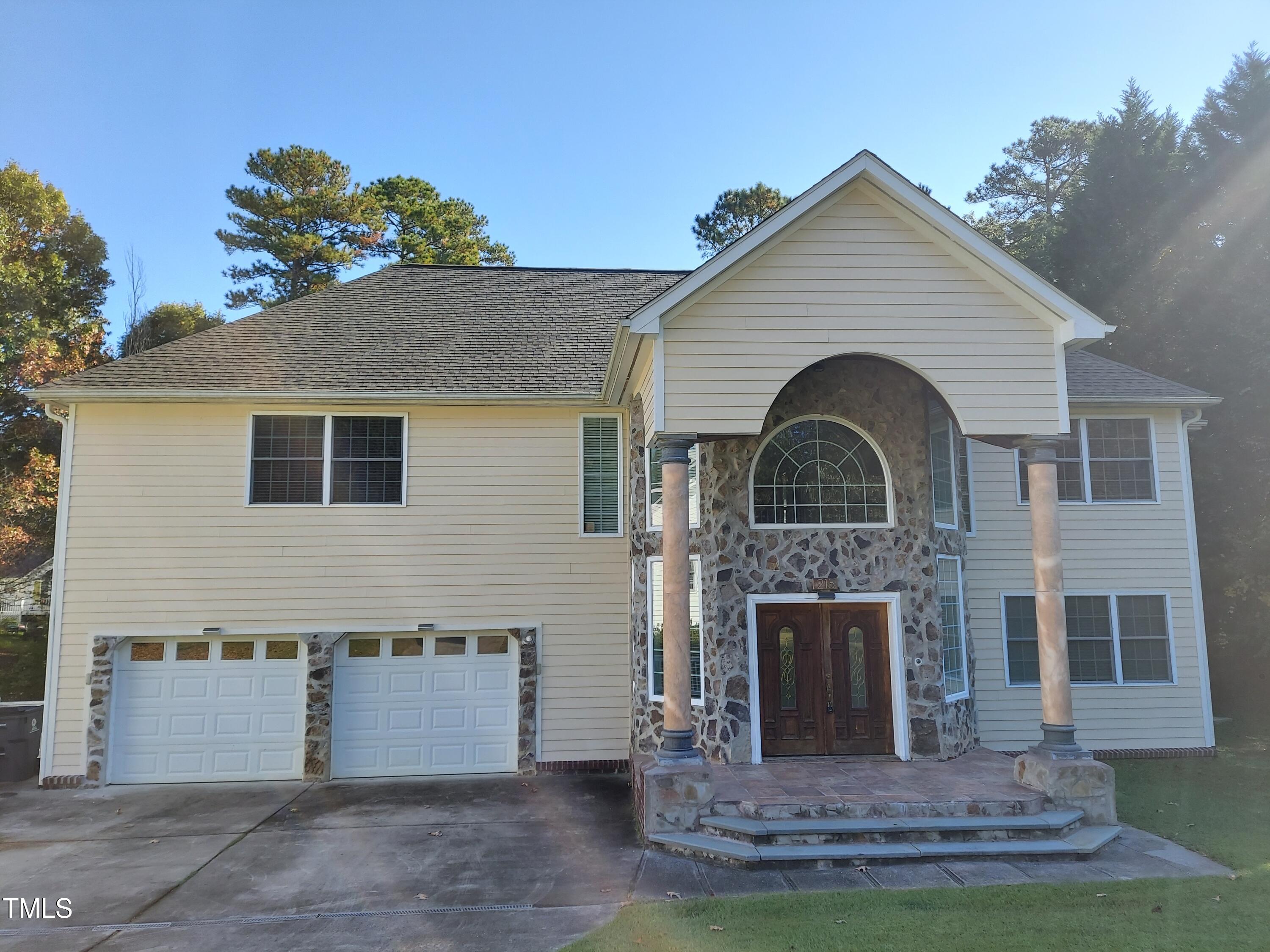 a front view of a house with a garden