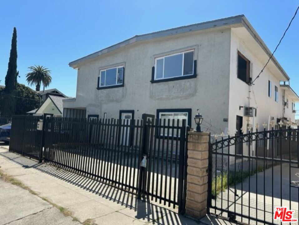 a view of a house with wooden fence