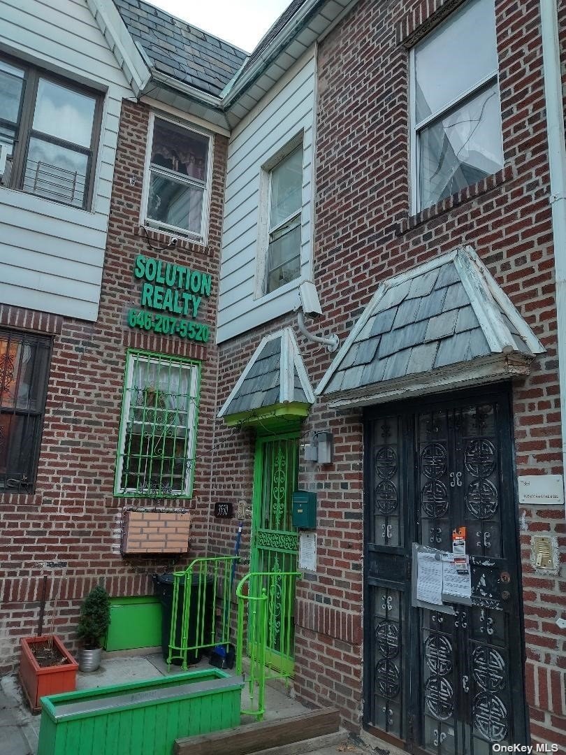 a front view of a house with plants