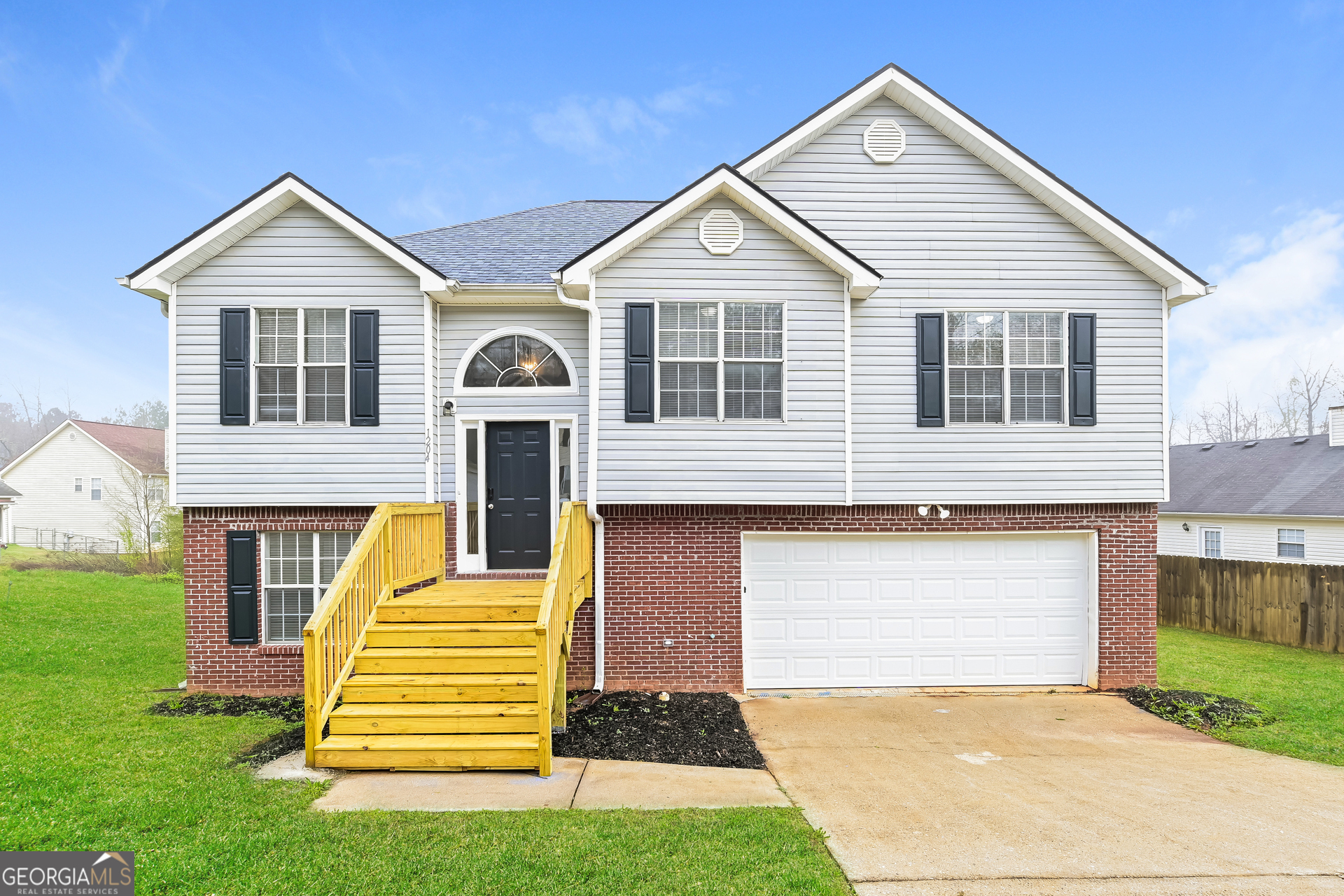 a front view of a house with a yard and garage