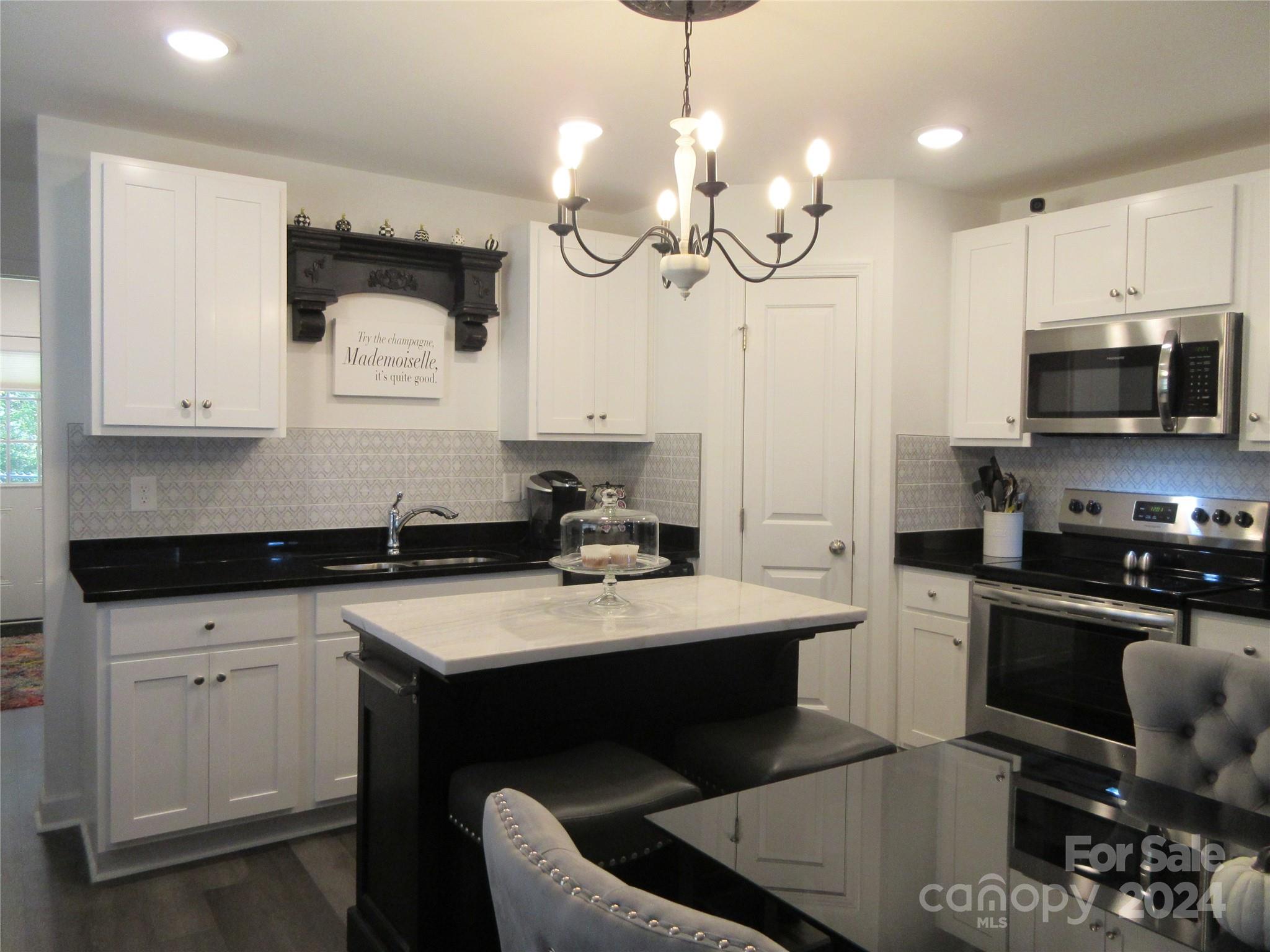 a kitchen with a sink stove and microwave