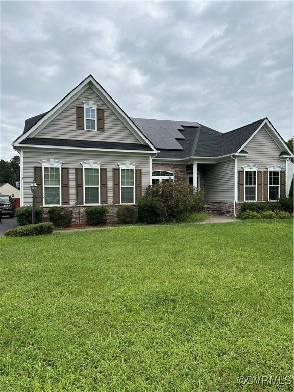 View of front of property with a front yard and so