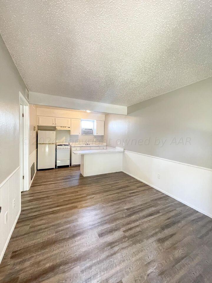 a view of a kitchen with wooden floor