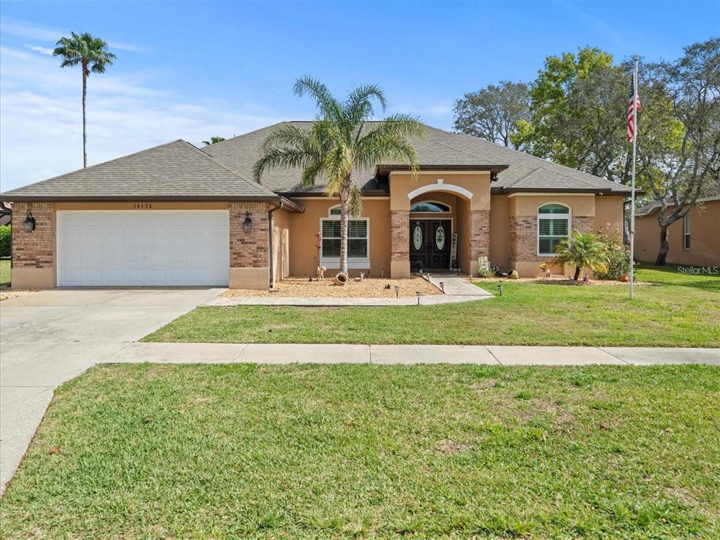 a front view of a house with a yard and garage