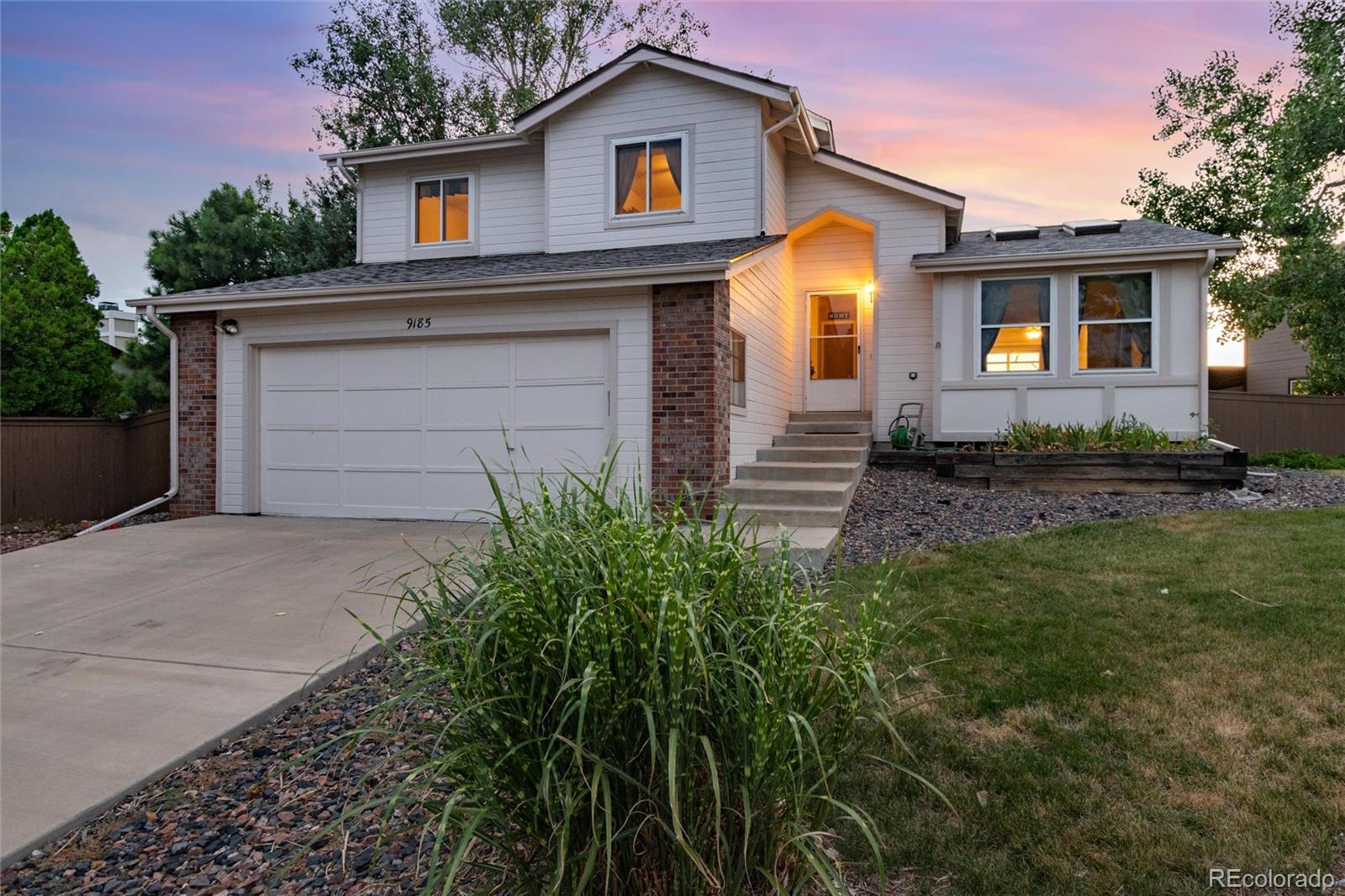 a front view of a house with a yard