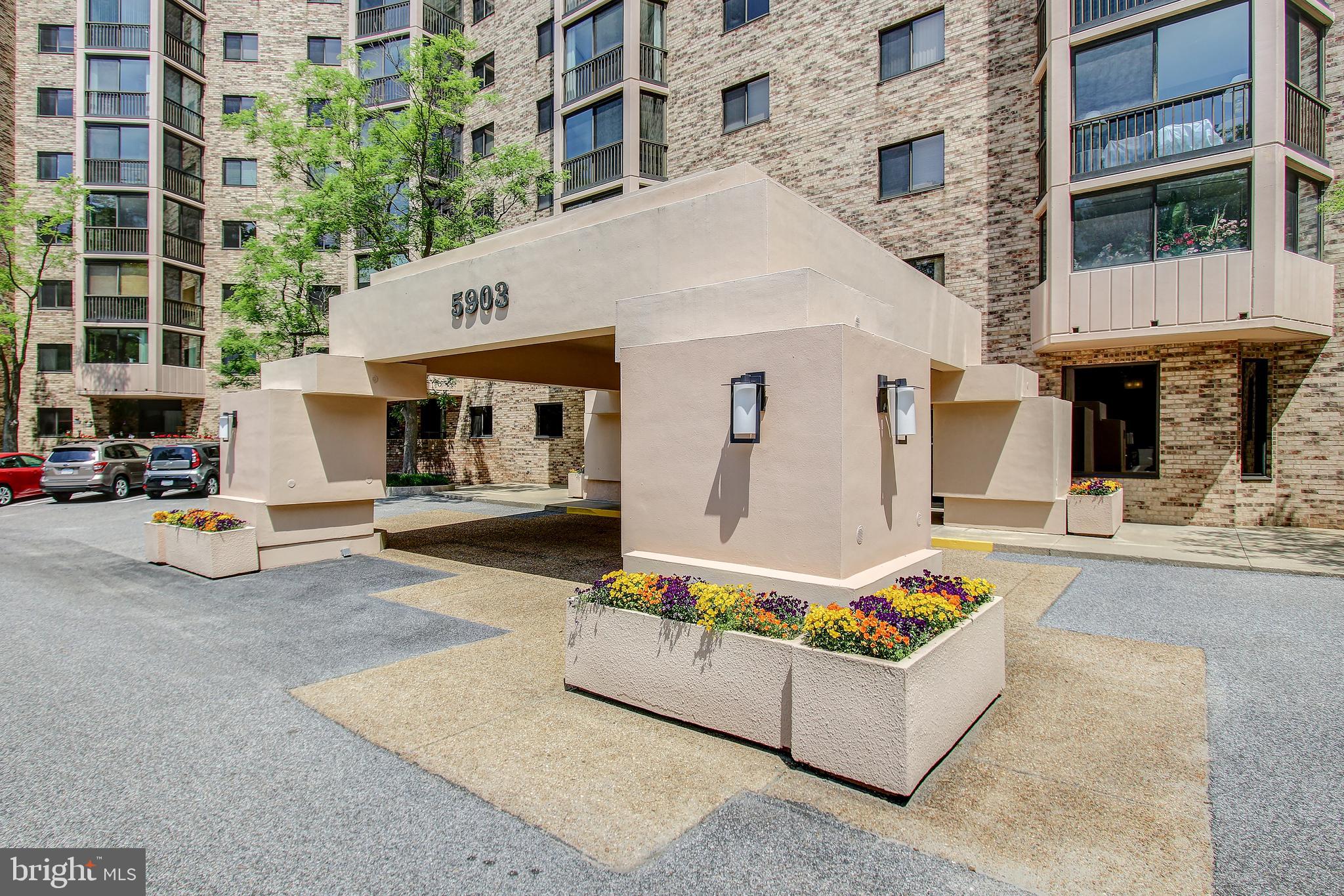 a building outdoor space with patio furniture and potted plants