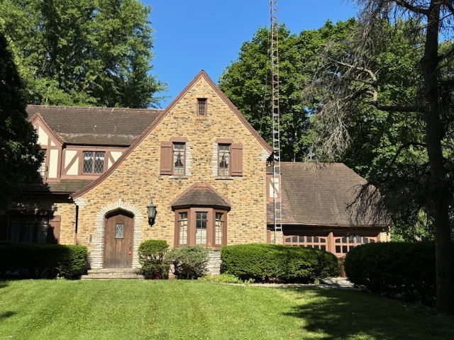 a front view of a house with a garden