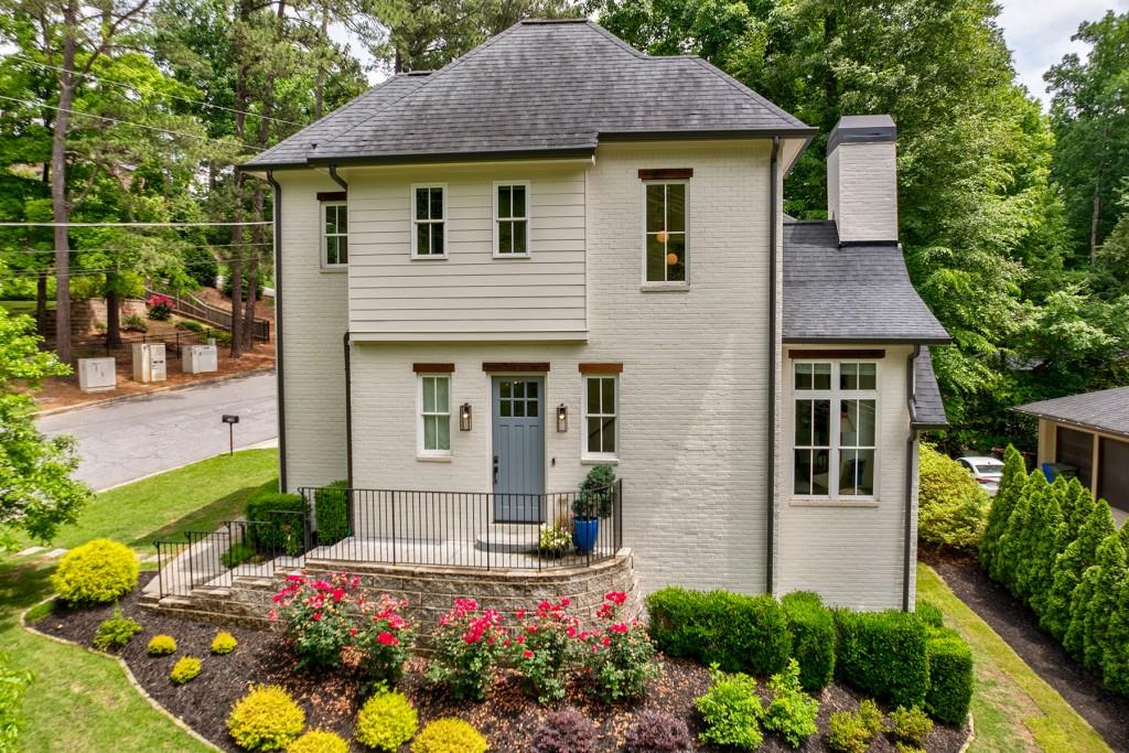 a front view of a house with a yard and garden