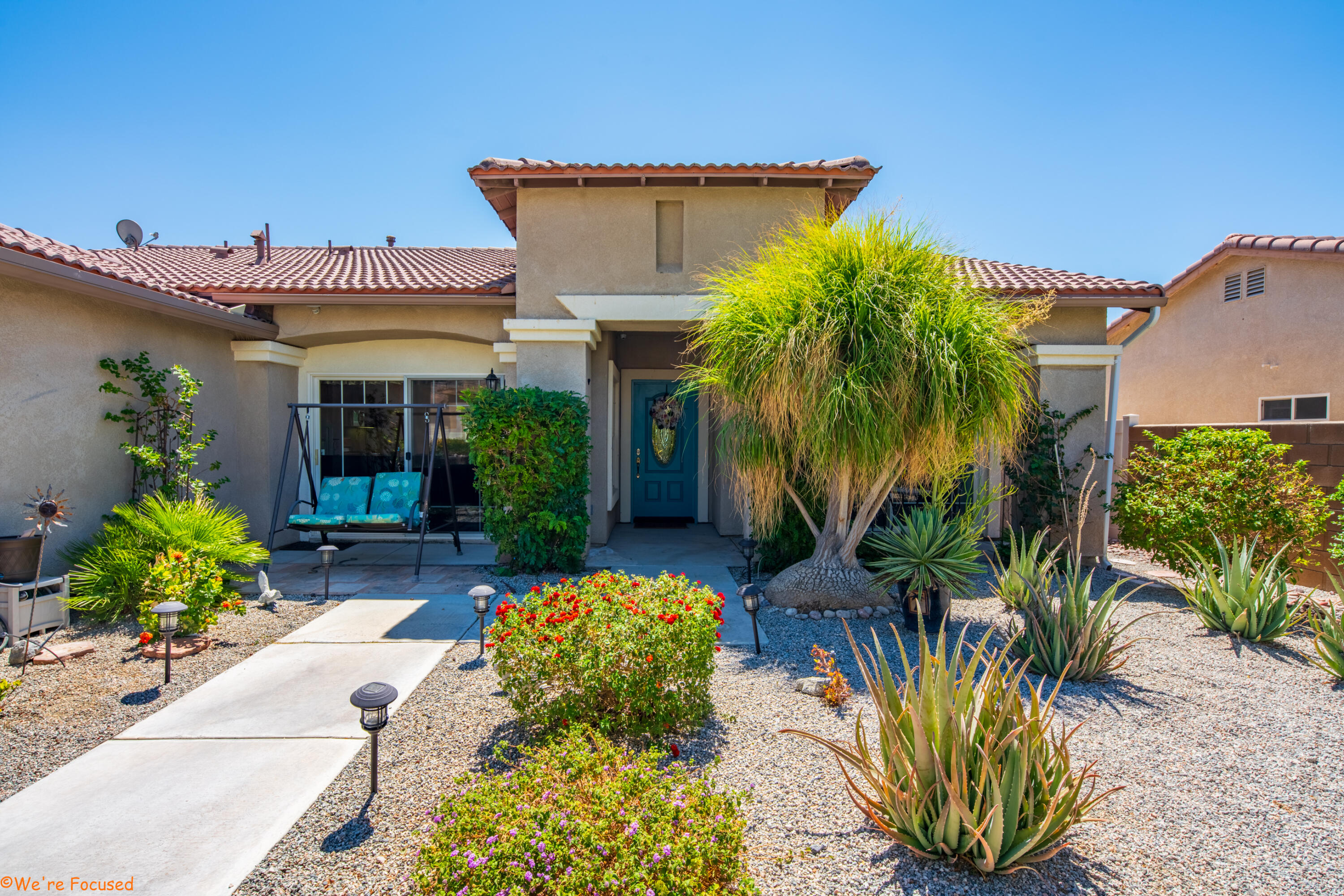 a view of a house with potted plants