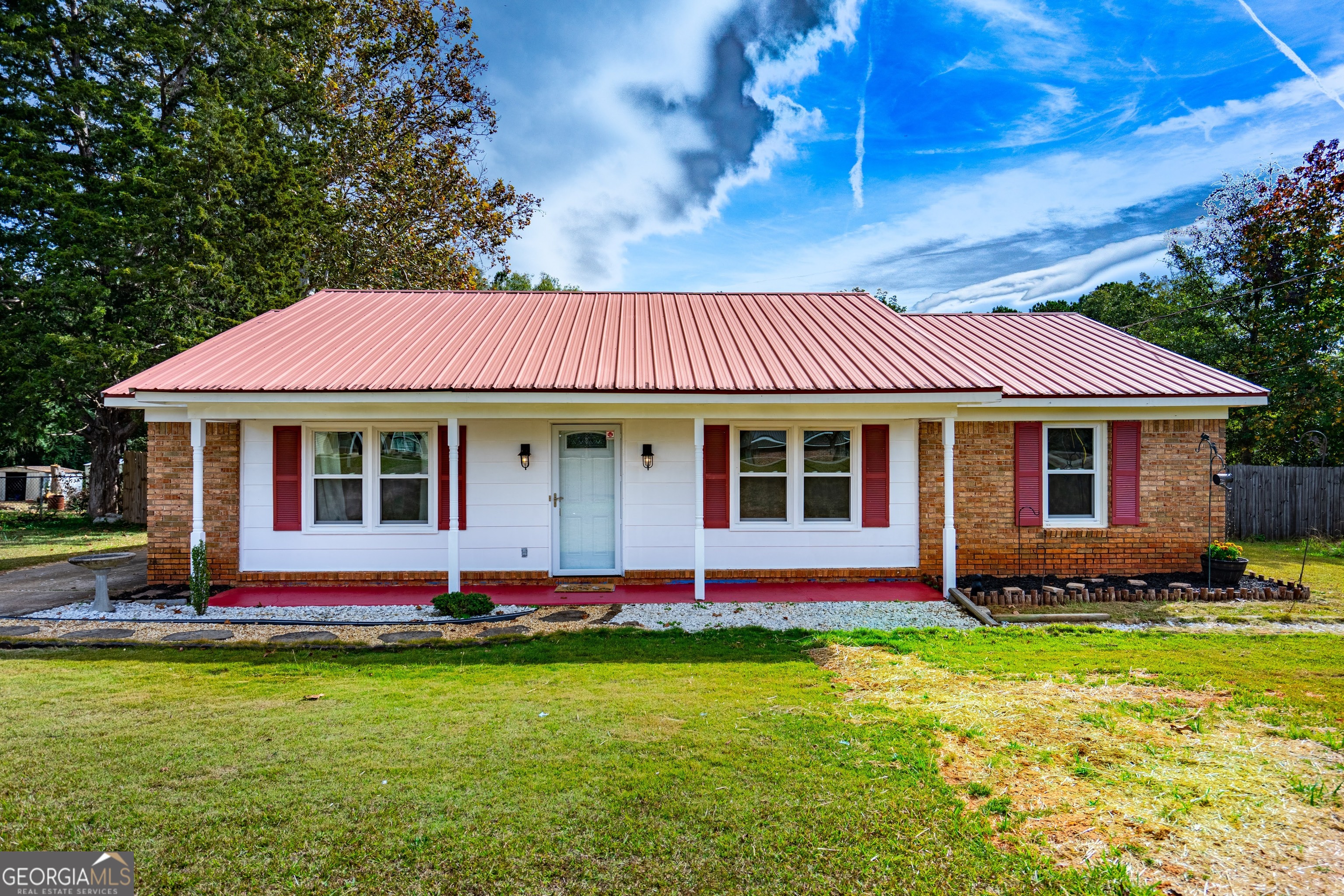 a front view of a house with a garden