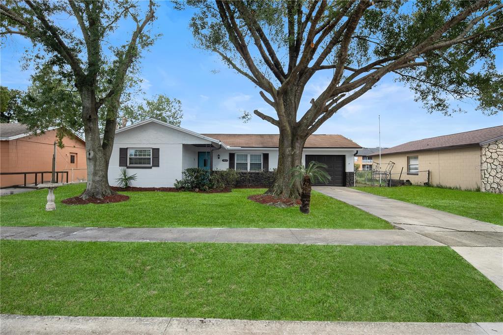 a front view of a house with a garden and yard